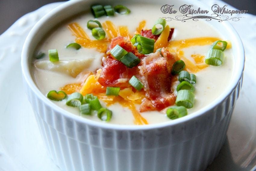 Thick ‘n Creamy Loaded Potato Soup - perfect for that cool Fall day or the middle of winter! Tender potatoes nestled in a creamy, cheesy soup with bacon, scallions and more cheese. #soup #breadbowl #cheesesoup #potatosoup #loadedbakedpotato #bakedpotato