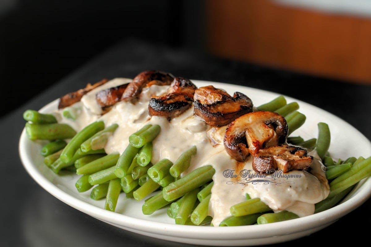 These Sophisticated green beans put an elevated twist on the classic green bean casserole. The Best homemade mushroom cream sauce drizzled over fresh green beans and caramelized mushrooms. Seriously, so incredibly delicious!