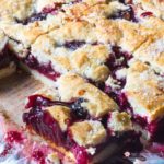 These cherry pie bars are filled with cherryrific pie filling layered in a no-roll, cookie pie crust. Perfect for parties as you can hold a drink in one hand and a cherry pie bar in the other!