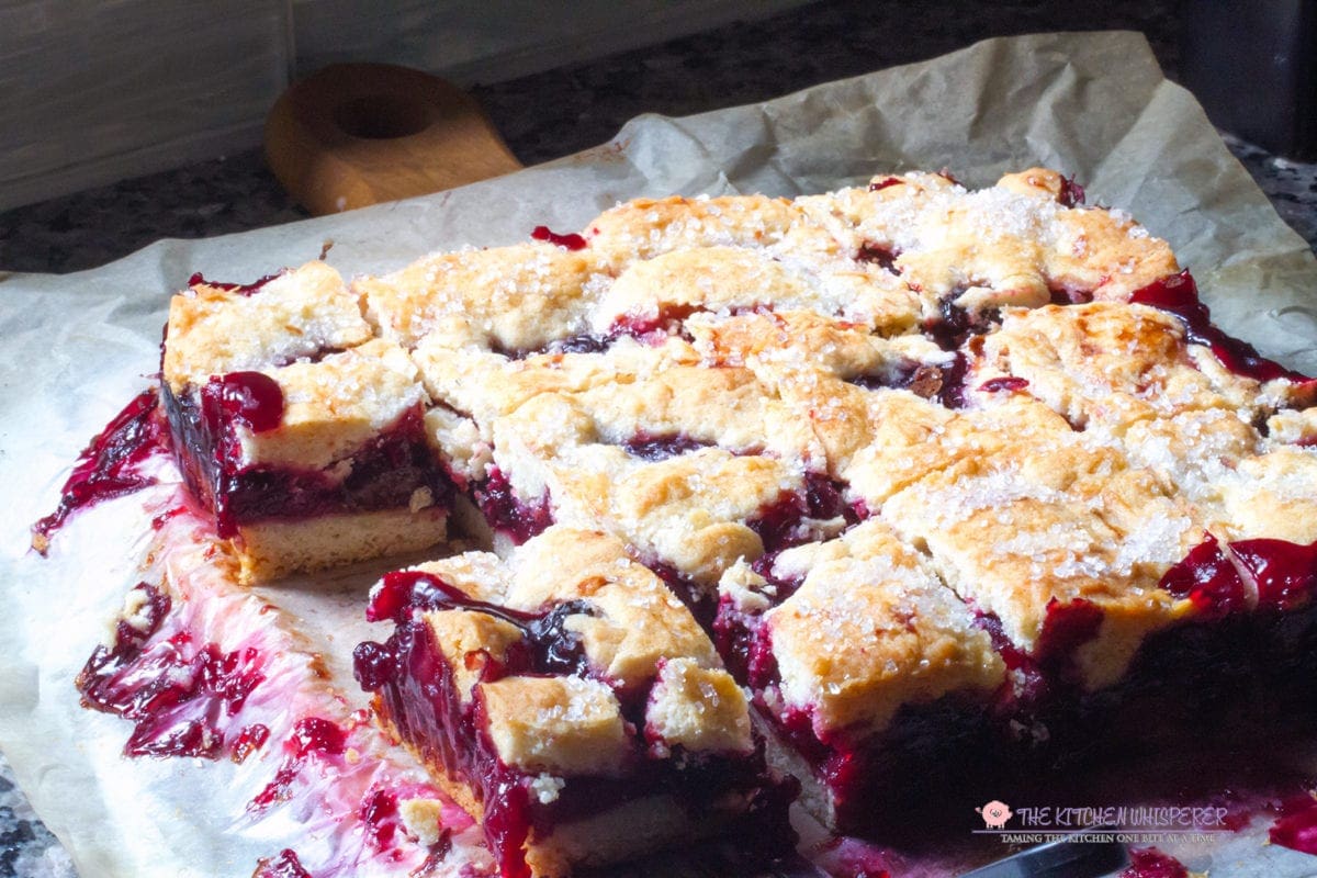 These cherry pie bars are filled with cherryrific pie filling layered in a no-roll, cookie pie crust. Perfect for parties as you can hold a drink in one hand and a cherry pie bar in the other!