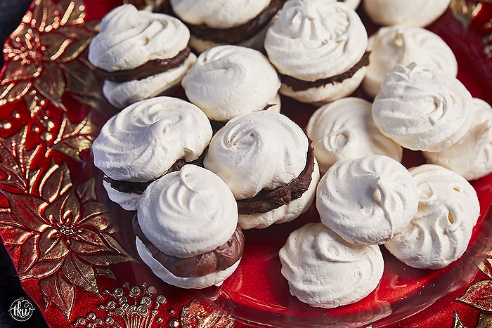 These French Vanilla Meringue Sandwich Cookies with Ganache filling are cloud-like treats that melt in your mouth with a slightly crisp outer shell, a slightly chewy center, and a decadent chocolate ganache filling.