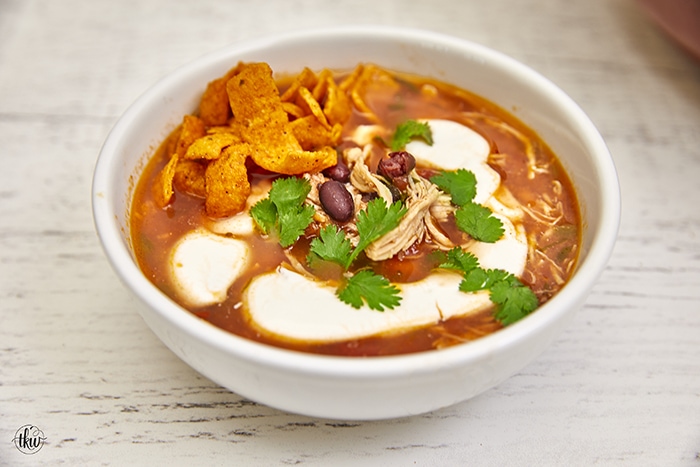 This soup features seasoned Mexican shredded chicken, beans, jalapenos, fresh herbs, smoky tomato broth, and a hint of lime making it the perfect soup on a chilly day. Chicken Tortilla Soup, best chicken tortilla soup recipe, Mexican chicken tortilla soup, easy chicken tortilla soup, classic chicken tortilla soup, white chicken tortilla soup, authentic chicken tortilla soup