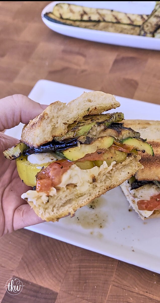 Perfectly grilled zucchini, chayote, and eggplant on a garlic butter grilled bun topped with grilled cheesy heirloom tomatoes and Italian herb oil.