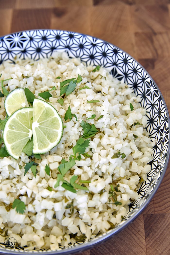 This riced cauliflower is gluten-Free, healthy, and absolutely delicious! Made in under 20 minutes and perfect as a side with your favorite Mexican meal, in a wrap, or as-is! Easy & Delicious Cilantro Lime Cauliflower Rice, cilantro lime cauliflower rice recipe, gluten-free cilantro lime rice, cauliflower rice, lime cilantro cauliflower rice, healthy rice, rice cauliflower, riced cilantro lime cauliflower, frozen cilantro lime cauliflower rice