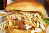 Adding BBQ pulled chicken topped with a lip-smacking applesauce BBQ sauce and crispy apple coleslaw to a soft brioche bun for one of the most amazing BBQ chicken sandwiches you’ll ever eat! The Most Amazing Pulled Chicken Sandwich with Crisp Apple Coleslaw, applesauce bbq sauce, apple coleslaw, appleslaw, apple bbq sauce, apple sauce bbq sauce, football food, tailgating, shredded chicken, bbq pulled chicken