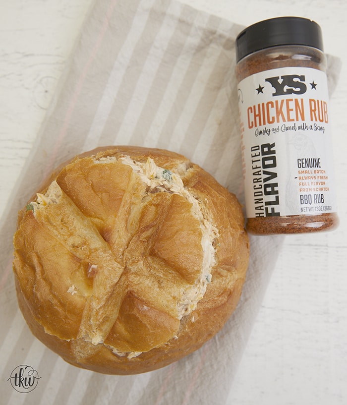 This cheesy smoked bread bowl is perfect for Sunday football or hanging out with friends. Stuffed with BBQ chicken, crispy bacon, cheese, and ranch seasoning, this over-the-top bread bowl is always a crowd favorite! Ultimate Smoked BBQ Chicken Bacon And Ranch Bread Bowl, stuffed bread bowl, crack chicken dip, bacon chicken ranch dip, smoked bread, yoder smokers, flattop grills
