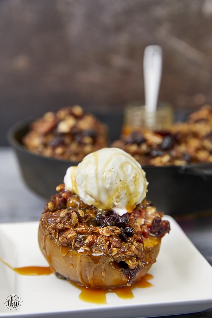 Fire up the smoker for the perfect fall dessert. These smoked apples are topped with maple, bourbon, craisins, and pecan oat streusel. All you need to decide is whether to top them with vanilla ice cream and a butterscotch drizzle or caramel. Streusel Crumb Smoked Apples with Maple Pecans and Bourbon, baked apples, smoked apple crisp, oat streusel, , yoder smokers, desserts in your smoker, pizza oven desserts, perfect fall dessert