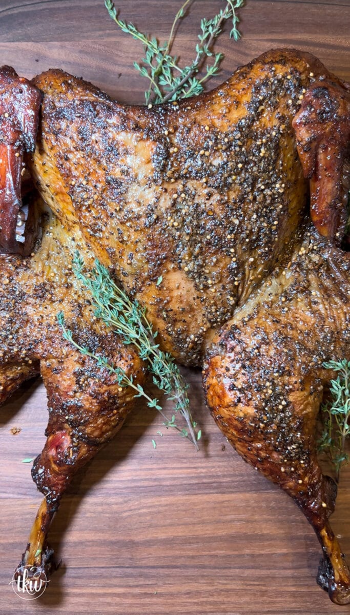 One of the most tender, juiciest, flavorful turkeys you'll ever eat! Spatchcock-style smoked Garlic herb butter-infused turkey meat smoked to perfection! The Best Smoked Spatchcock Thanksgiving Turkey, smoked turkey, thanksgiving dinner, easy turkey dinner, butter injection, perfect thanksgiving turkey