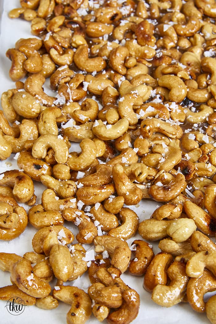These skillet-toasted candied cashews are truly one of the best crunchy sweet snacks! Coated in a candied honey sugar coating and finished with flaky sea salt, you'll be hard-pressed to stop eating them! Easy Candied Honey Sugar Crunch Hot Salted Cashews, candied nuts, holiday nuts, sugared nuts, christmas food gifts, diy gifts, hostess gifts, holiday snacks, crunchy nuts