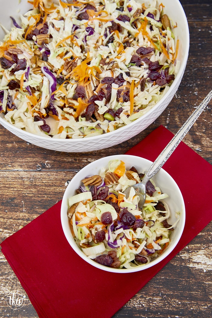 A combination of tart dried cranberries, crispy pecans & crisp coleslaw coated the most amazing creamy sweet maple dressing. The perfect cooler weather coleslaw to pair with your holiday meats! The Best Cranberry Pecan Coleslaw With Creamy Maple Dressing, thanksgiving coleslaw, sweet maple dressing, fall coleslaw, cranberry cabbage slaw, coleslaw recipe with cranberries, cranberry maple coleslaw, coleslaw with cranberries and pecans
