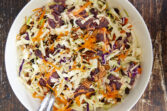 A combination of tart dried cranberries, crispy pecans & crisp coleslaw coated the most amazing creamy sweet maple dressing. The perfect cooler weather coleslaw to pair with your holiday meats! The Best Cranberry Pecan Coleslaw With Creamy Maple Dressing, thanksgiving coleslaw, sweet maple dressing, fall coleslaw, cranberry cabbage slaw, coleslaw recipe with cranberries, cranberry maple coleslaw, coleslaw with cranberries and pecans