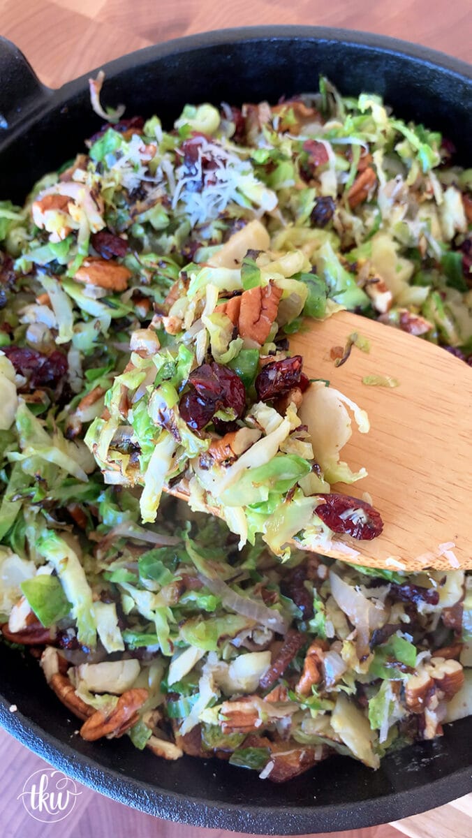 Our favorite holiday and summer salad! Shaved Brussels sprouts & shallots grilled in bacon drippings mixed with toasted pecans, and cranberries then drizzled with a maple dijon vinaigrette. Ultimate Grilled Brussels Sprouts Salad With Bacon Pecans and Cranberries, big green egg salad, maple dijon vinaigrette, grilled salad, warm salad, thanskgiving side dish, christmas side dish, summer salad, bacon and brussels sprouts salad