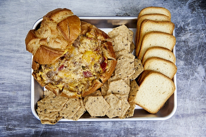The perfect game-day dish! Grilled Italian crumbled meatballs, zesty pepperoni, & cheese stuffed in a bread bowl then smoked to cheesy perfection! The Best Smoked Cheesy Meatball Pepperoni Bread Bowl, grilled meatballs, cheesy bread bowl, football foods, game day appetizers, stuffed bread, big green egg smoked bread