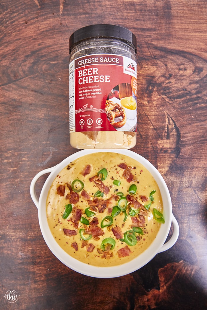 This loaded cheesy dip starts with the Hoosier Hill Beer Cheese Mix, more beer, shredded cheddar & smoked Gouda, crispy bacon, and minced jalapenos! This dip comes together in minutes! Ultimate Loaded Beer Bacon Jalapeno Cheese Dip, beer cheese, hot beer cheese dip, pretzel dip, football food, cheesy dip, beer dip