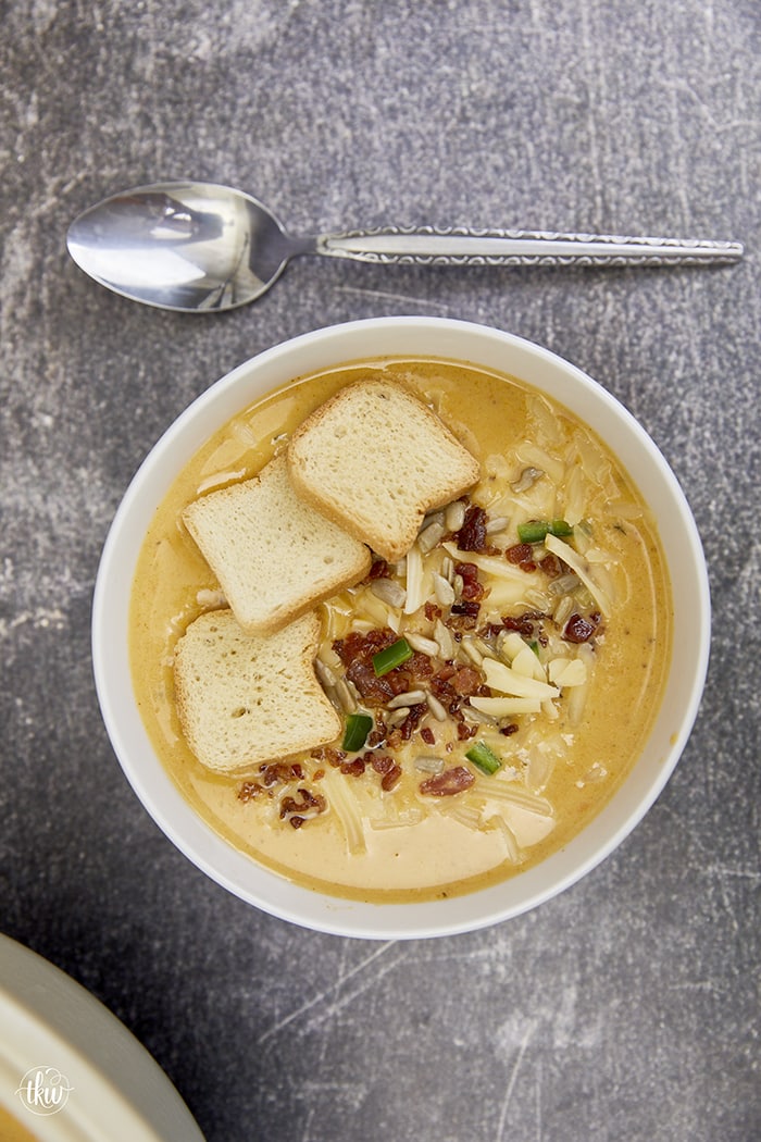 Smoked butternut squash with jalapenos, crispy bacon, cheese & white beans makes this the perfect creamy cold-weather soup! Ultimate Creamy Smoked Butternut Squash White Bean Bacon Soup, smoked winter squash, creamy butternut squash soup, northern bean soup, winter soups, yoder smokers soups