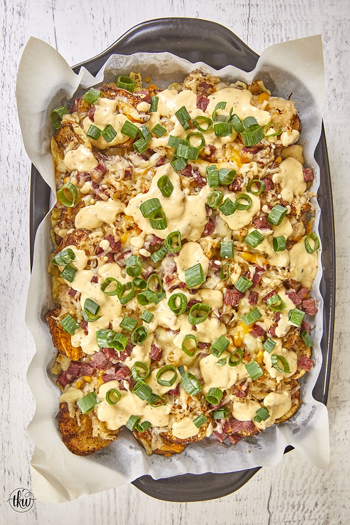 Pub-Style Irish Nachos are crispy thin potatoes topped with 3 types of cheeses, corned beef, sauerkraut, green onions and beer cheese. Ultimate Crunchy Pub Grub: Crispy Potato Sauerkraut Irish Nachos, corned beef and sauerkraut, crispy potato nachos, cheesy potatoes, baked cheesy potatoes, sauerkraut