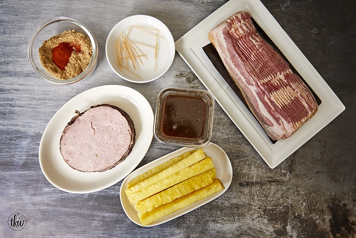 Get ready for a mouthwatering culinary adventure with a sweet and savory twist. Imagine crispy bacon, candied ham, juicy pineapple that's baked to perfection and finished with a decadent buttery maple bourbon glaze!Ultimate Buttery Maple Bourbon Glazed Candied Bacon Pineapple Spears, bacon wrapped pineapple, yoder smokers pizza oven, maple bourbon butter sauce, candied ham, summer cookout recipes, cookout appetizers, grilled pineapple