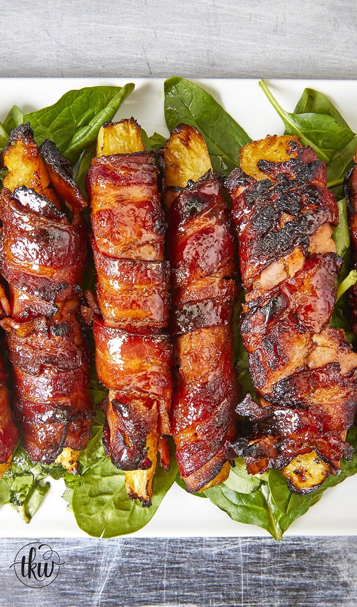 Get ready for a mouthwatering culinary adventure with a sweet and savory twist. Imagine crispy bacon, candied ham, juicy pineapple that's baked to perfection and finished with a decadent buttery maple bourbon glaze!Ultimate Buttery Maple Bourbon Glazed Candied Bacon Pineapple Spears, bacon wrapped pineapple, yoder smokers pizza oven, maple bourbon butter sauce, candied ham, summer cookout recipes, cookout appetizers, grilled pineapple