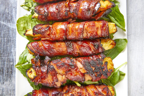 Get ready for a mouthwatering culinary adventure with a sweet and savory twist. Imagine crispy bacon, candied ham, juicy pineapple that's baked to perfection and finished with a decadent buttery maple bourbon glaze!Ultimate Buttery Maple Bourbon Glazed Candied Bacon Pineapple Spears, bacon wrapped pineapple, yoder smokers pizza oven, maple bourbon butter sauce, candied ham, summer cookout recipes, cookout appetizers, grilled pineapple