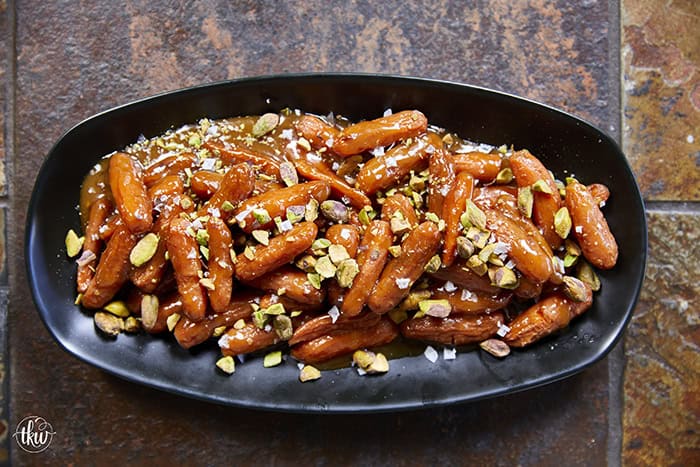 Turn ordinary carrots into something unforgettable! Roasted in a buttery, spiced maple sauce, then topped with toasted pistachios and a kiss of sea salt flakes, this side dish is guaranteed to steal the spotlight at any meal!