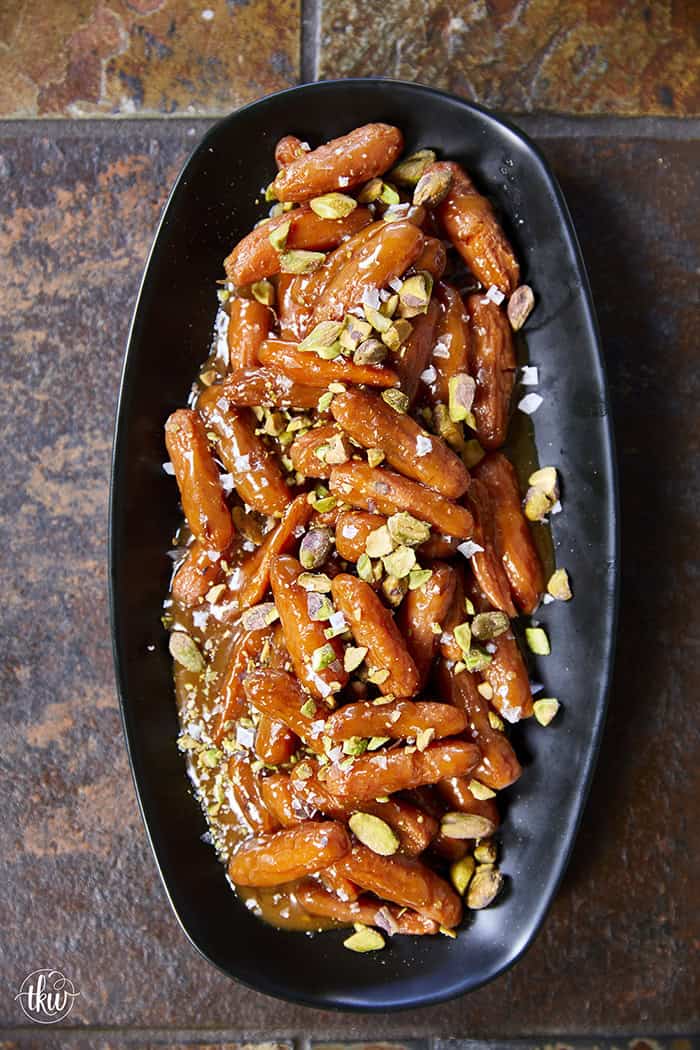 Turn ordinary carrots into something unforgettable! Roasted in a buttery, spiced maple sauce, then topped with toasted pistachios and a kiss of sea salt flakes, this side dish is guaranteed to steal the spotlight at any meal!