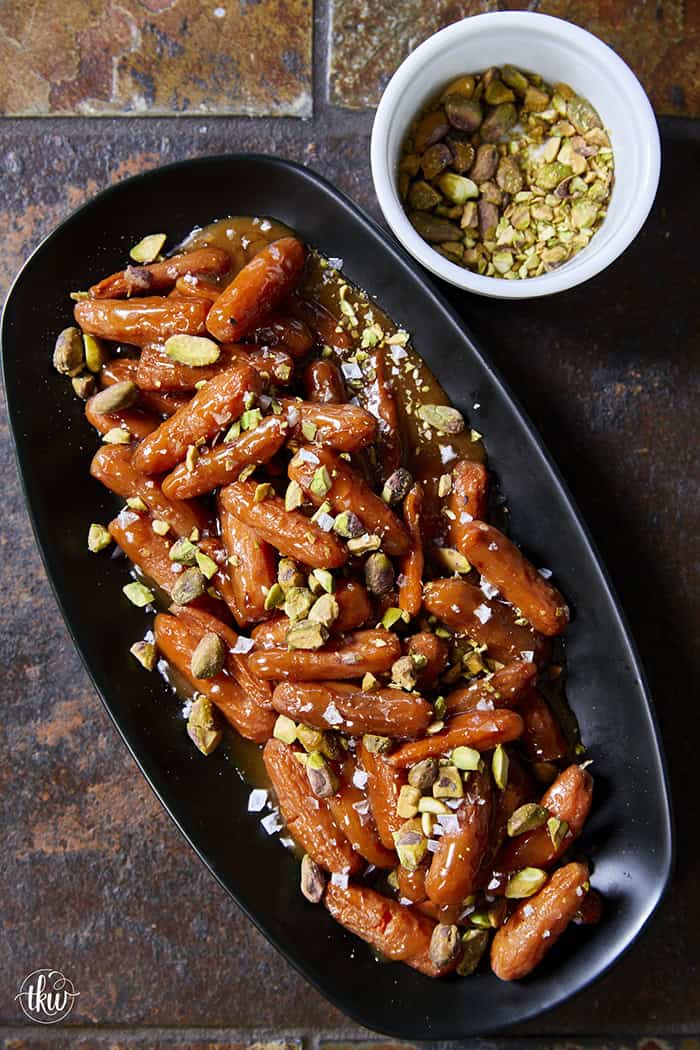 Turn ordinary carrots into something unforgettable! Roasted in a buttery, spiced maple sauce, then topped with toasted pistachios and a kiss of sea salt flakes, this side dish is guaranteed to steal the spotlight at any meal!