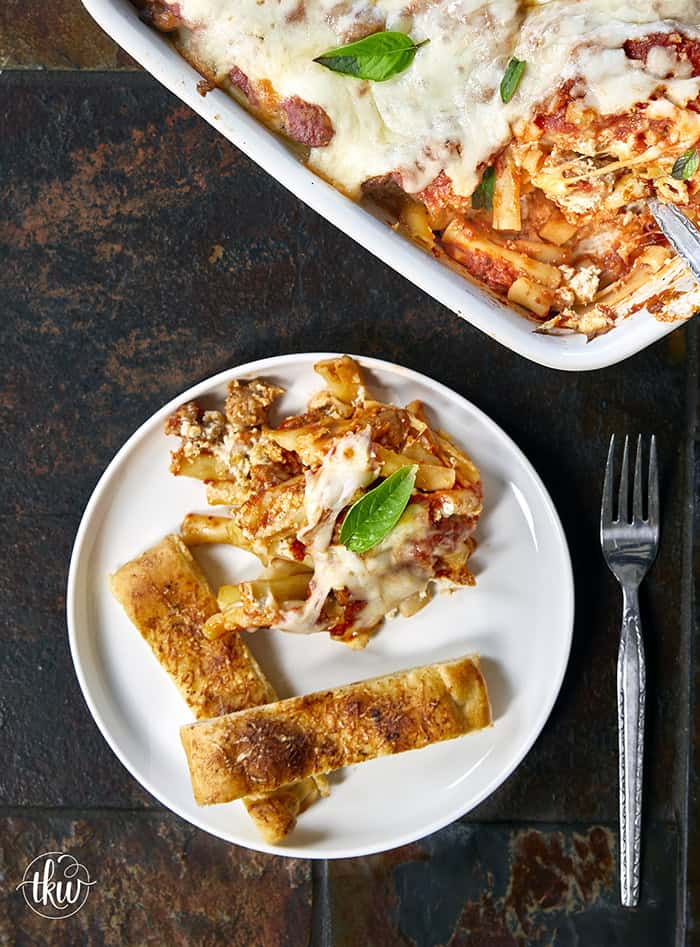When you need something warm, hearty, & comforting that everyone will love, this dish always hits the spot. Layers of rich marinara, tender ziti, creamy three-cheese ricotta filling, and zesty Italian sausage come together to create a bubbling, irresistibly cheesy dinner everyone will love.