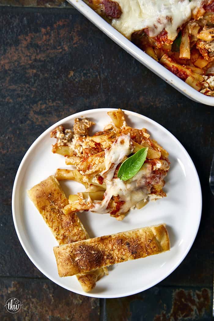When you need something warm, hearty, & comforting that everyone will love, this dish always hits the spot. Layers of rich marinara, tender ziti, creamy three-cheese ricotta filling, and zesty Italian sausage come together to create a bubbling, irresistibly cheesy dinner everyone will love.
