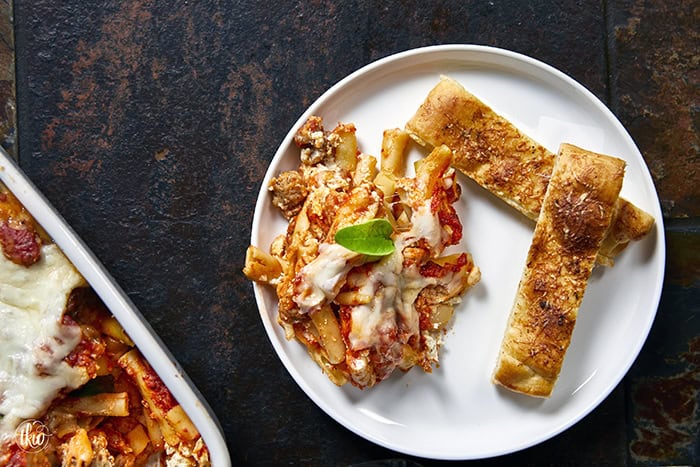 When you need something warm, hearty, & comforting that everyone will love, this dish always hits the spot. Layers of rich marinara, tender ziti, creamy three-cheese ricotta filling, and zesty Italian sausage come together to create a bubbling, irresistibly cheesy dinner everyone will love.
