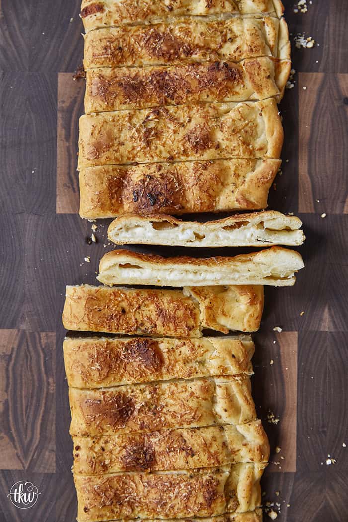 These cheese-stuffed breadsticks are the perfect blend of warm pizza dough, savory garlic butter, and gooey mozzarella for an irresistible bite! Made with simple pantry ingredients, they come together quickly for a delicious snack or the perfect side to any pizza or pasta night.