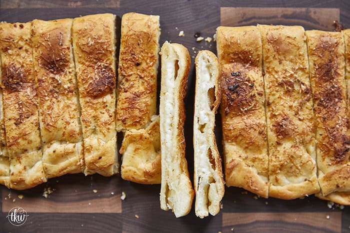 These cheese-stuffed breadsticks are the perfect blend of warm pizza dough, savory garlic butter, and gooey mozzarella for an irresistible bite! Made with simple pantry ingredients, they come together quickly for a delicious snack or the perfect side to any pizza or pasta night.