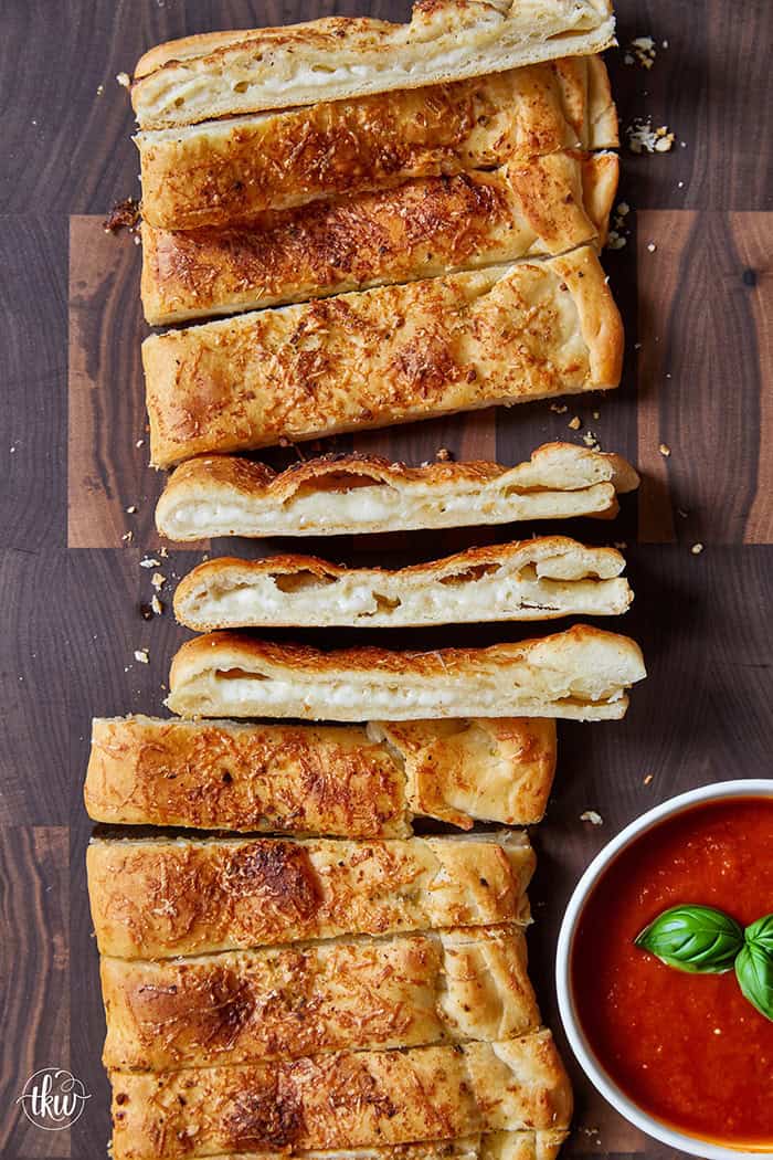 These cheese-stuffed breadsticks are the perfect blend of warm pizza dough, savory garlic butter, and gooey mozzarella for an irresistible bite! Made with simple pantry ingredients, they come together quickly for a delicious snack or the perfect side to any pizza or pasta night.