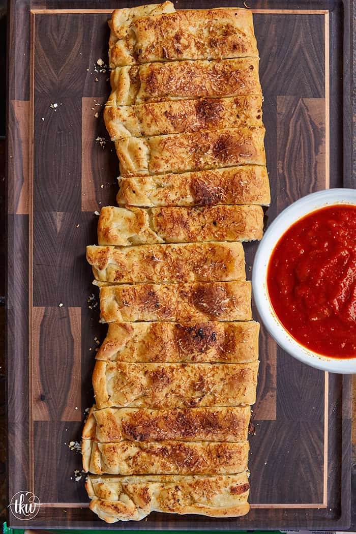 These cheese-stuffed breadsticks are the perfect blend of warm pizza dough, savory garlic butter, and gooey mozzarella for an irresistible bite! Made with simple pantry ingredients, they come together quickly for a delicious snack or the perfect side to any pizza or pasta night.