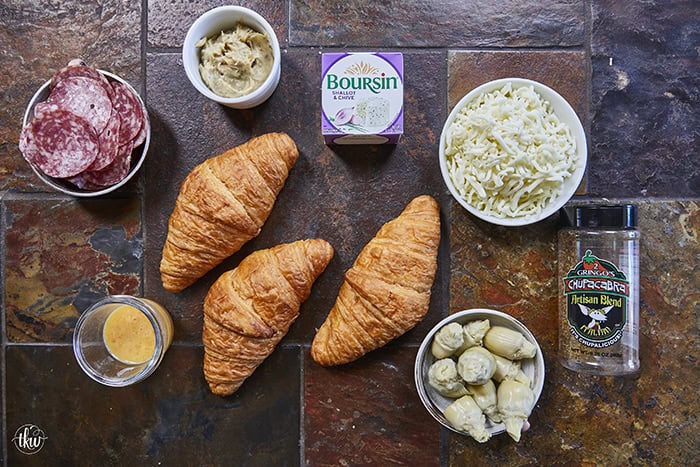 Buttery, flaky croissants stuffed with garlic butter spread, Boursin cheese, Italian meats, artichoke hearts, and mozzarella cheese. Topped with tomato slices, fresh basil, and a drizzle of balsamic glaze, they bake up perfectly golden, freeze beautifully, and are an easy Italian-inspired meal anytime!