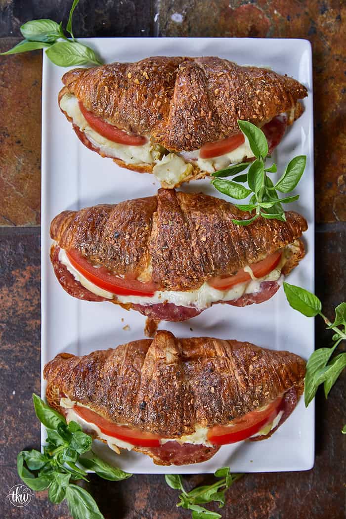 Buttery, flaky croissants stuffed with garlic butter spread, Boursin cheese, Italian meats, artichoke hearts, and mozzarella cheese. Topped with tomato slices, fresh basil, and a drizzle of balsamic glaze, they bake up perfectly golden, freeze beautifully, and are an easy Italian-inspired meal anytime!