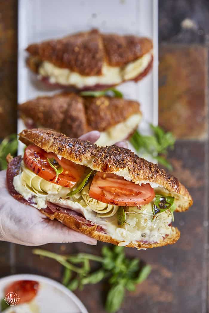 Buttery, flaky croissants stuffed with garlic butter spread, Boursin cheese, Italian meats, artichoke hearts, and mozzarella cheese. Topped with tomato slices, fresh basil, and a drizzle of balsamic glaze, they bake up perfectly golden, freeze beautifully, and are an easy Italian-inspired meal anytime!