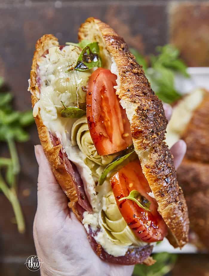 Buttery, flaky croissants stuffed with garlic butter spread, Boursin cheese, Italian meats, artichoke hearts, and mozzarella cheese. Topped with tomato slices, fresh basil, and a drizzle of balsamic glaze, they bake up perfectly golden, freeze beautifully, and are an easy Italian-inspired meal anytime!