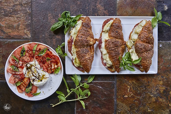 Buttery, flaky croissants stuffed with garlic butter spread, Boursin cheese, Italian meats, artichoke hearts, and mozzarella cheese. Topped with tomato slices, fresh basil, and a drizzle of balsamic glaze, they bake up perfectly golden, freeze beautifully, and are an easy Italian-inspired meal anytime!