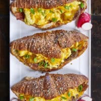 Flaky, buttery croissants stuffed with fluffy eggs, crispy bacon, savory sausage, melty cheese, and a luscious maple Dijon butter. They bake up golden, freeze like a dream, and deliver a bite of pure breakfast bliss any time of the day!