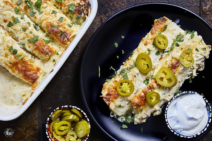 Creamy, comforting, and seriously easy, these white chicken enchiladas will immediately become a family favorite! Soft flour tortillas packed with well-seasoned chicken and cheeses, then smothered in the most decadent sour cream sauce. Perfect for a quick weeknight meal, meal prep, and freezer meals!