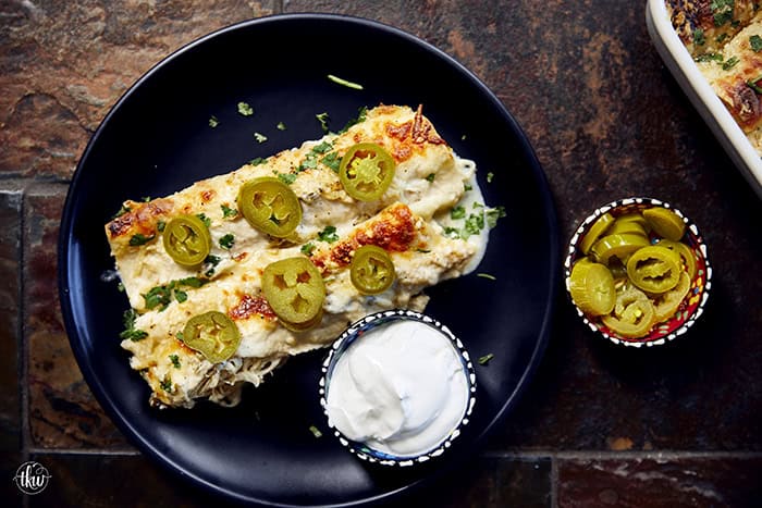 Creamy, comforting, and seriously easy, these white chicken enchiladas will immediately become a family favorite! Soft flour tortillas packed with well-seasoned chicken and cheeses, then smothered in the most decadent sour cream sauce. Perfect for a quick weeknight meal, meal prep, and freezer meals!