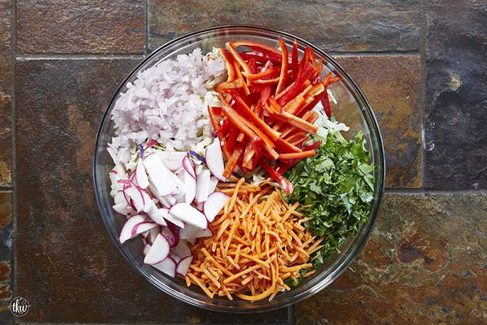 Fresh, crunchy, and bursting with bold flavor, this Thai-inspired Asian coleslaw features crisp cabbage, bell peppers, carrots, and crunchy peanuts all tossed in a creamy, spicy peanut butter dressing.