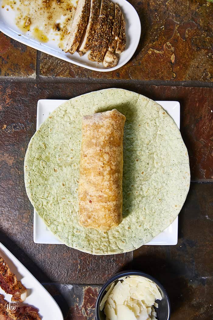 Juicy oven-baked chicken, crispy bacon, fresh lettuce, and creamy Parmesan-peppercorn dressing come together in a soft flour tortilla for the ultimate chicken wrap. These 6-ingredient wraps are perfect for meal prep, busy schedules, and grab-and-go bites!