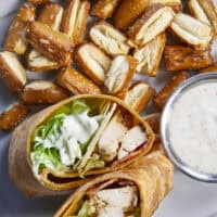 Juicy oven-baked chicken, crispy bacon, fresh lettuce, and creamy Parmesan-peppercorn dressing come together in a soft flour tortilla for the ultimate chicken wrap. These 6-ingredient wraps are perfect for meal prep, busy schedules, and grab-and-go bites!