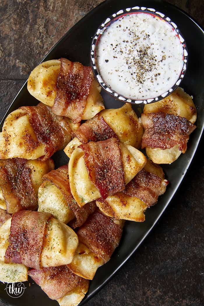 Crispy, creamy, and incredibly snackable, these baked bacon-wrapped pierogies are always the first to go. Made with just 3 simple ingredients, the pierogies stay soft and creamy on the inside while the seasoned bacon wrapping turns perfectly crispy. This is the bite that everyone keeps reaching for!