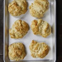There is nothing quite like the smell of warm, buttery biscuits in the kitchen to bring back those childhood memories of Mom's kitchen. My family's tried-and-true buttermilk drop biscuits are pure love, with a golden crunch, a fluffy center, and a buttery bite!