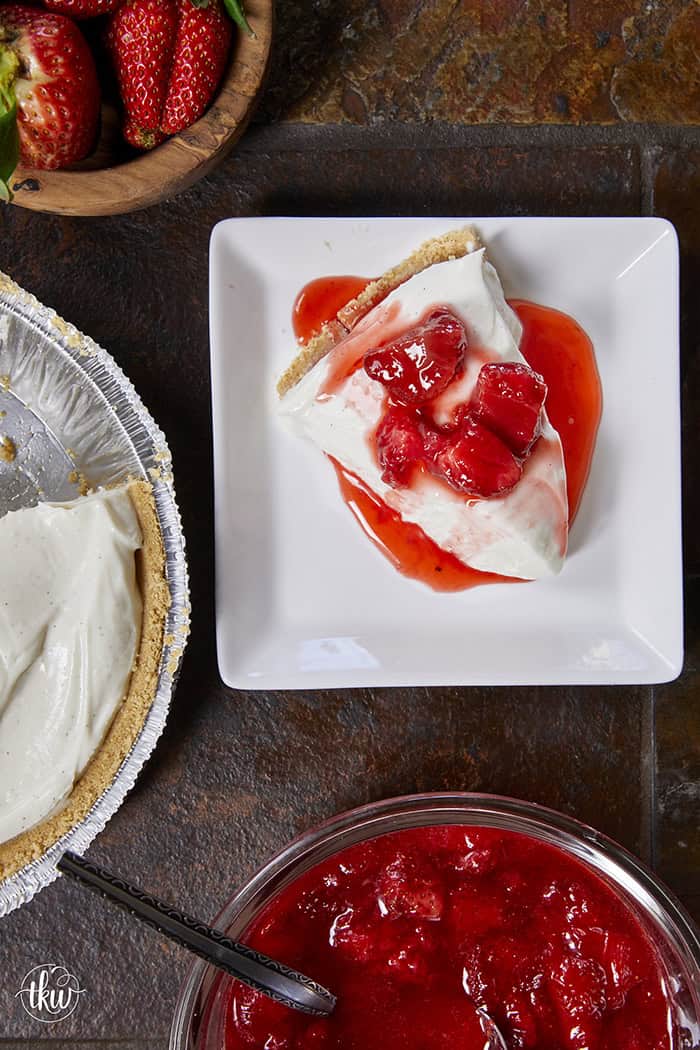 A close-up slice of silky, no-bake ricotta cheesecake on a plate, highlighting the light, velvety texture and real vanilla bean seeds.