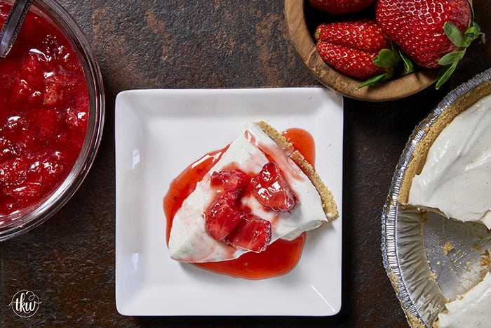A close-up slice of silky, no-bake ricotta cheesecake on a plate, highlighting the light, velvety texture and real vanilla bean seeds.