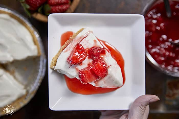 A close-up slice of silky, no-bake ricotta cheesecake on a plate, highlighting the light, velvety texture and real vanilla bean seeds.