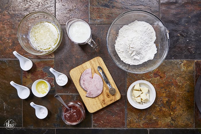 Taking my family's classic buttermilk drop biscuit recipe and give it a sophisticated, savory upgrade with savory ham, melted brie, fig jam, and black pepper. Perfect any time of the day, meal prep, and freeze meals. #ButtermilkBiscuits #BrunchRecipes #SavoryBaking #ComfortFood #stuffedbiscuits #hamandcheesebiscuits